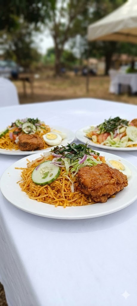 Professional event catering service - plated jollof rice dishes at outdoor gathering